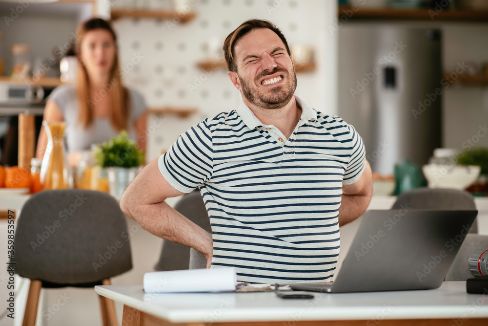 Young man working on project. Handsome man working at home.
Young man working on project. Handsome man working at home.