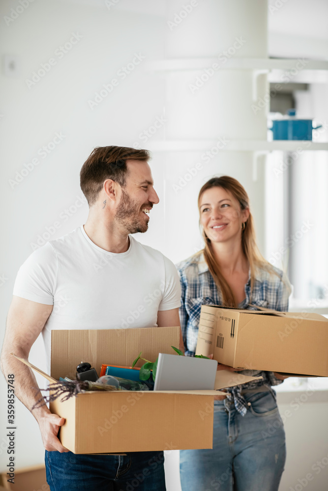 Husband and wife are moving in a apartment. Husband and wife are unpacking their belongins. Husband and wife are moving in a apartment. Husband and wife are unpacking their belongins.