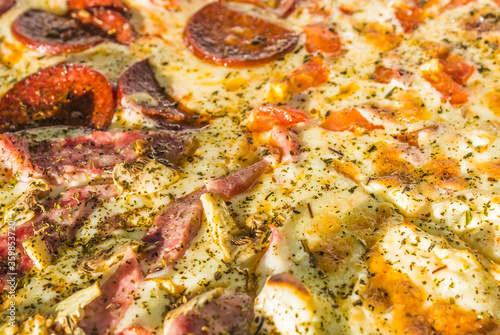 fresh cooked hot pizza close up with tomatoes, pepperoni and mushrooms in the delivery box. fast food summer concept