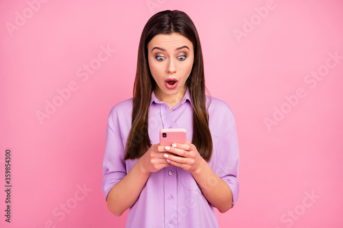 Close-up portrait of her she nice attractive lovely pretty charming addicted amazed cheerful long-haired girl using cell browsing web news isolated over pink pastel color background