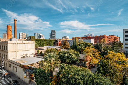 A view of area of Poblenou, old industrial district converted into new modern neighbourhood with trees and parks in coastal zone of Barcelona, Spain