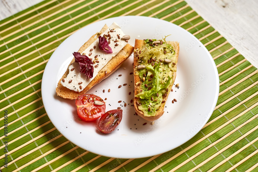 Toasted baguette with avocado and cheese.