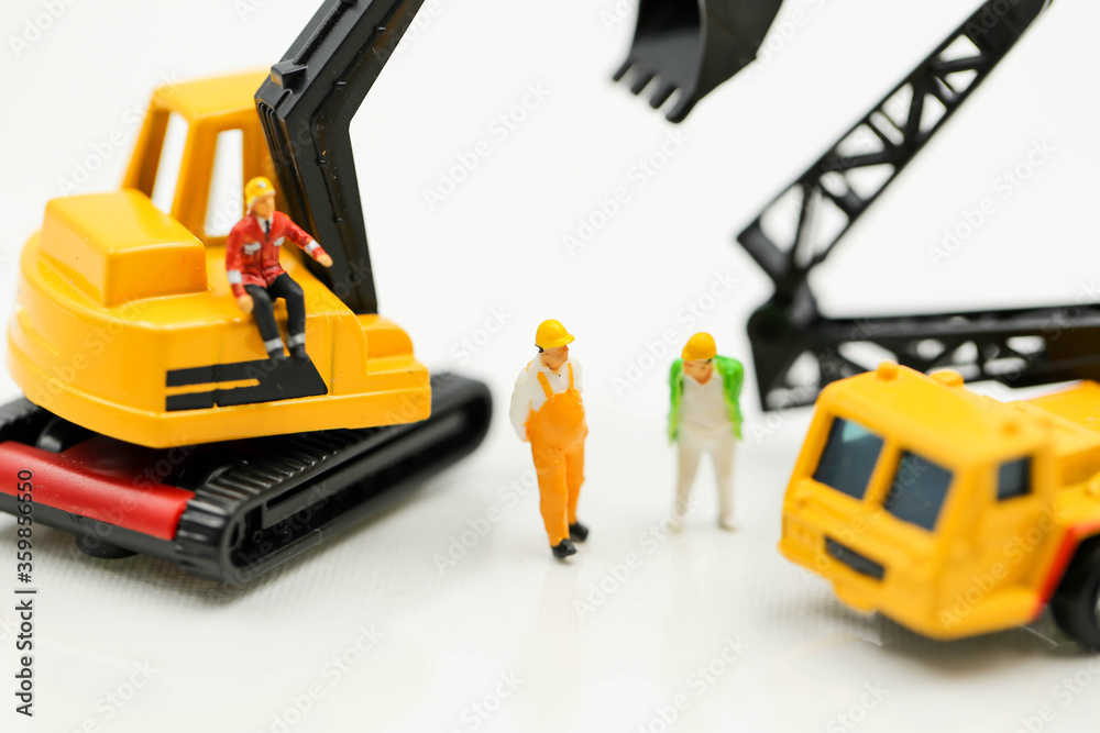 Miniature people : Group of worker and Engineer in a construction site with digger Tractor Miniature people : Group of worker and Engineer in a construction site with digger Tractor