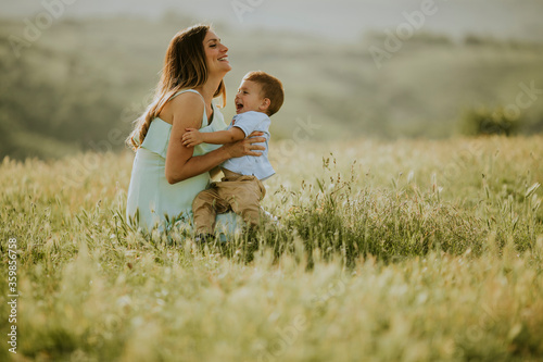 Young pregnant mother with ...