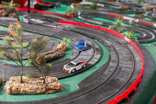 Electric slot cars on toy race track © JackF