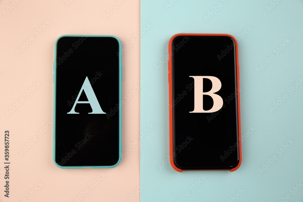 Conversion funnel, A B test in marketing and online advertising. Two smartphone with colored letters A and B on colorful background. Conversion funnel, A B test in marketing and online advertising. Two smartphone with colored letters A and B on colorful background.