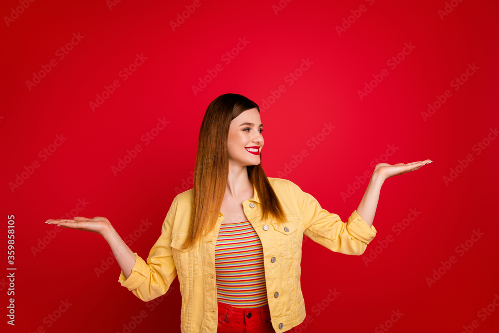 Photo of beautiful lady hold two open palms arms advising novelty product low price shopping select pick one better wear casual yellow blazer jacket isolated bright red color background Photo of beautiful lady hold two open palms arms advising novelty product low price shopping select pick one better wear casual yellow blazer jacket isolated bright red color background