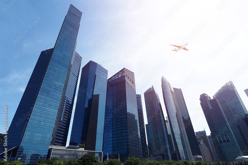 High rise building with aeroplane on blue sky High rise building with aeroplane on blue sky