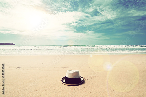 vintage style ocean sea beach clean clear sand with straw hat