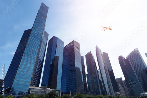 High rise building with aeroplane on blue sky