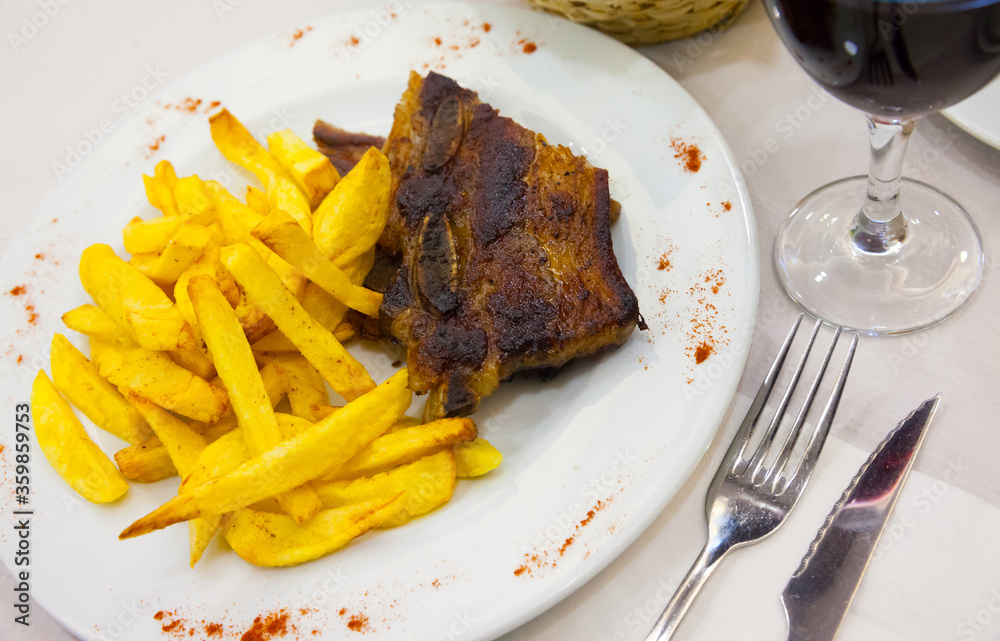 Tasty beef steak with  french fries served at plate, spanish dish