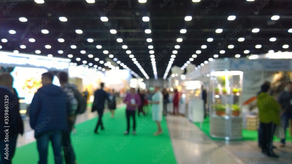 Abstract blur people in trade show background. New modern exhibition, convention and conference expo centre. Venue for holding business. Financial and economic growth and crisis concept. Collaboration