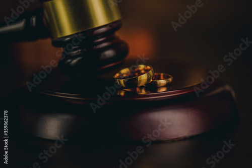 Close-up Of Wedding Rings And Wooden Gavel.