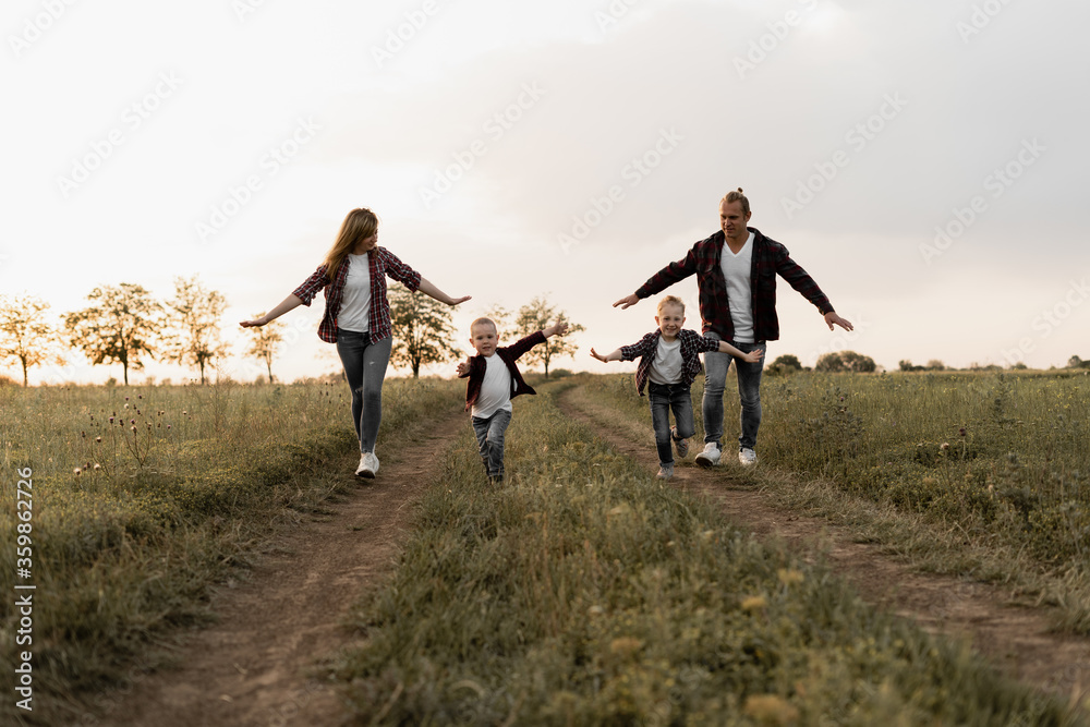 happy family father, mother and two sons. Camping at sunset. happy family father, mother and two sons. Camping at sunset.