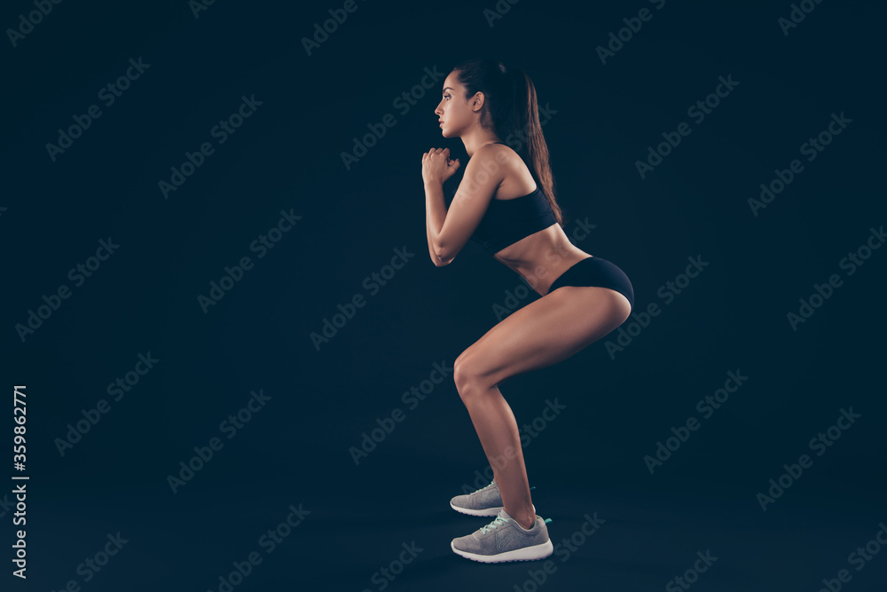 Full size profile photo short sport suit lady body weight workout sit ups improving ass muscles isolated black background
