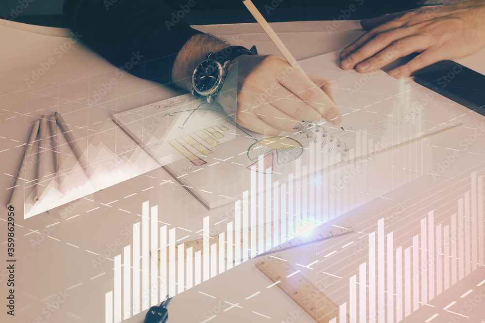 Double exposure of man's hands writing notes of stock market with forex chart. Double exposure of man's hands writing notes of stock market with forex chart.