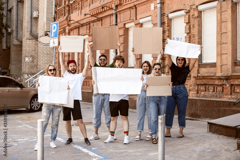 Diverse group of people protesting with blank sign. Protest against ...