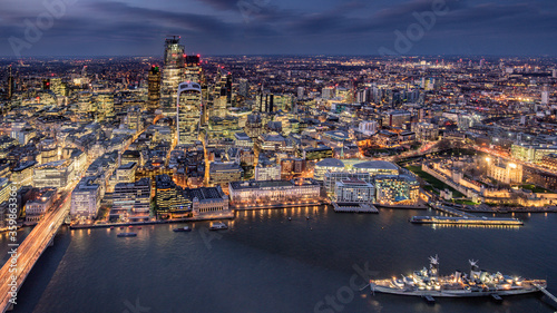London city area skyline and buildings aerial photograph at night showing offices and office lights. Financial and banking district. 