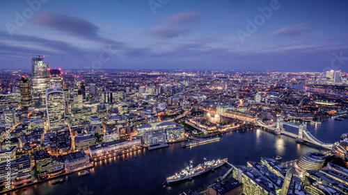 London city area skyline and buildings aerial photograph at night showing offices and office lights with Tower Bridge, the Tower of London and River Thames
