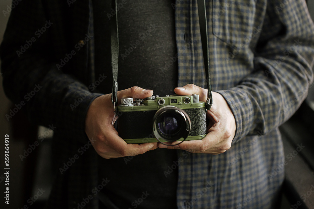 man in shirt man hands holds film green camera retro Horizontal man in shirt man hands holds film green camera retro Horizontal