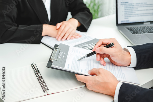 Senior manager HR reading a resume during a job interview employee young woman meeting Applicant and recruitment. Interview concept