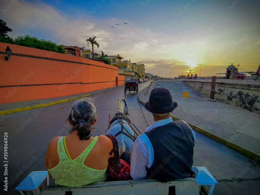 CARTAGENA, COLOMBIA - NOVEMBER 09, 2019: Horse drawn touristic carriages in the historic Spanish colonial city of Cartagena de Indias, Colombia