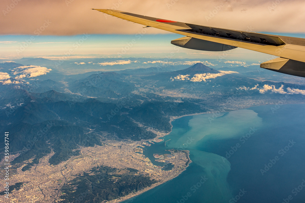 Aerial airplane view of Shizuoka and Suruga Bay, with iconic Mount Fuji in the distance, Japan Aerial airplane view of Shizuoka and Suruga Bay, with iconic Mount Fuji in the distance, Japan