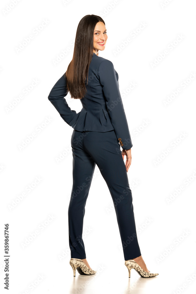 Back view of young smiling business woman in a pants and jacket Back view of young smiling business woman in a pants and jacket