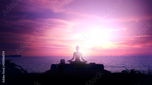 Meditation at magnificent sunset in the ocean.