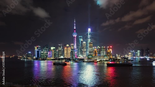 TL/ Asia, China, Shanghai, Time lapse of the Shanghai skyline and Pudong river, at dusk, with cargo ships and tour boats passing by