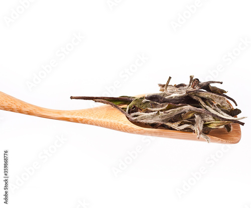 Bai Mu Dan (White Peony) chinese white tea in a scoop isolated on a white background. photo