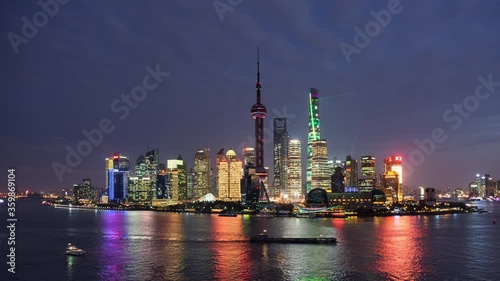 TL/ Asia, China, Shanghai, Time lapse of the Pudong skyline and Pudong river, at dusk, with cargo ships and tour boats passing by