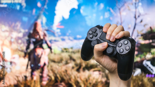 Man hand holding joystick while playing the game.