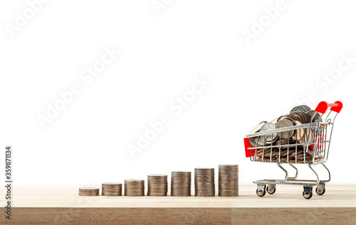 Business and financial, Shopping concept, Money stack step growing growth with shopping cart and trolley on a white background. photo