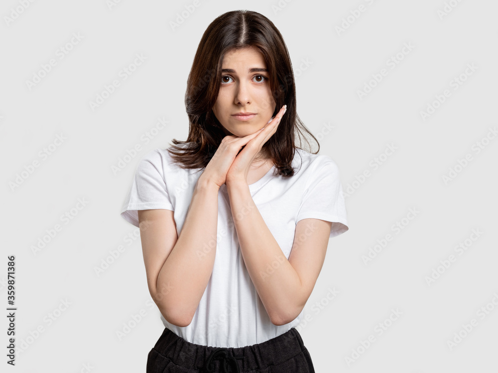 Apologizing woman portrait. Forgiveness faith. Regretful lady feeling sorry isolated on neutral background. Apologizing woman portrait. Forgiveness faith. Regretful lady feeling sorry isolated on neutral background.