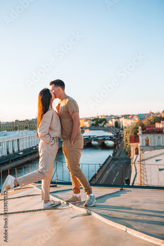 Family on rooftop enjoying with view of beautiful sunset in Sankt Petersburg in Russia