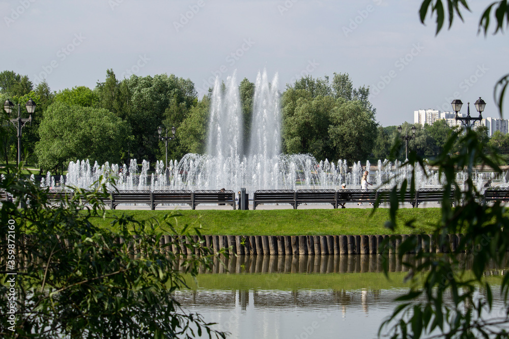 Water fountain in the city park summer