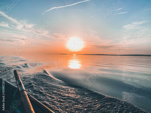 sunset over the sea and boat with oars