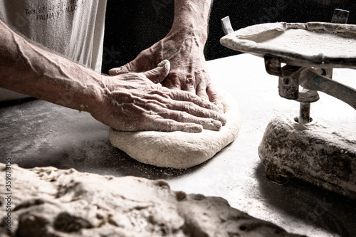 Baker working the bread dough.