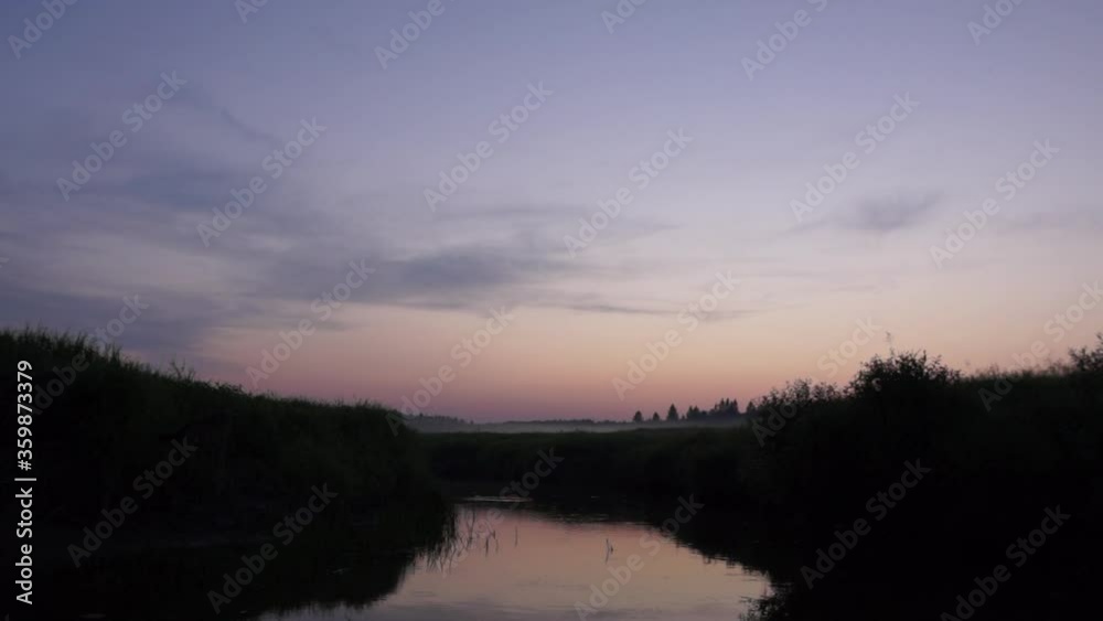 Fog creeps along the river at sunset. Outdoors in the late summer evening. Fog creeps along the river at sunset. Outdoors in the late summer evening.
