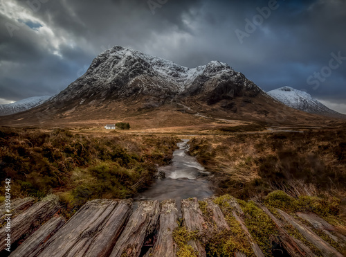 Glencoe in the winter, snow capped mountain and cottage. 