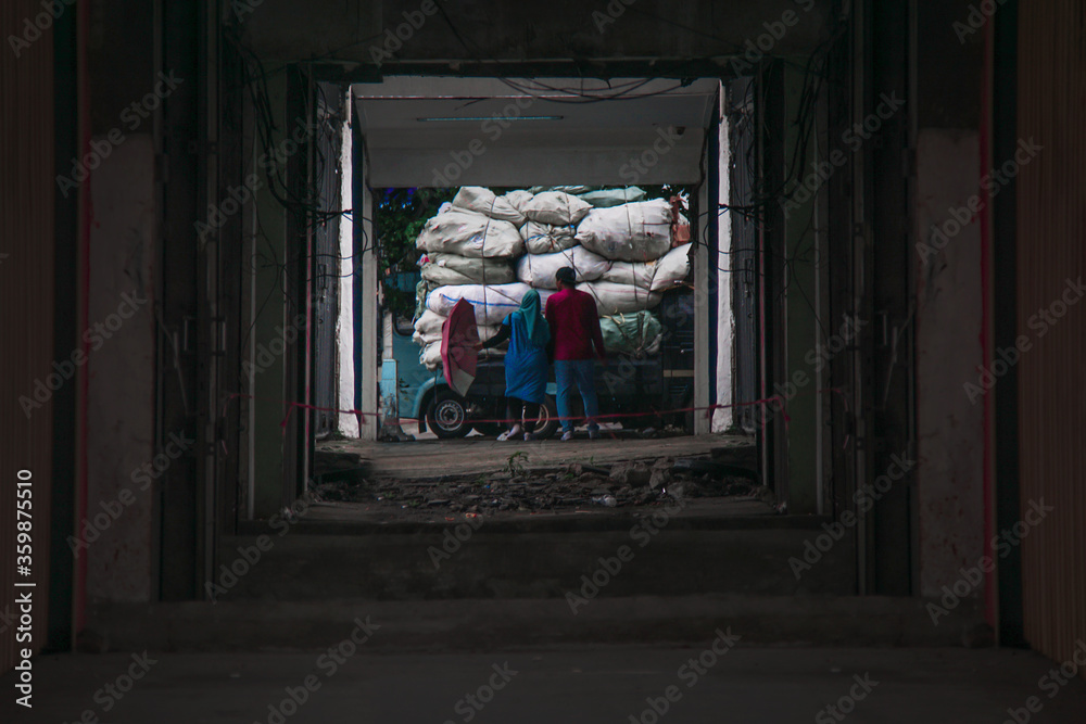 Dark abandon entrance building with two people woman and man