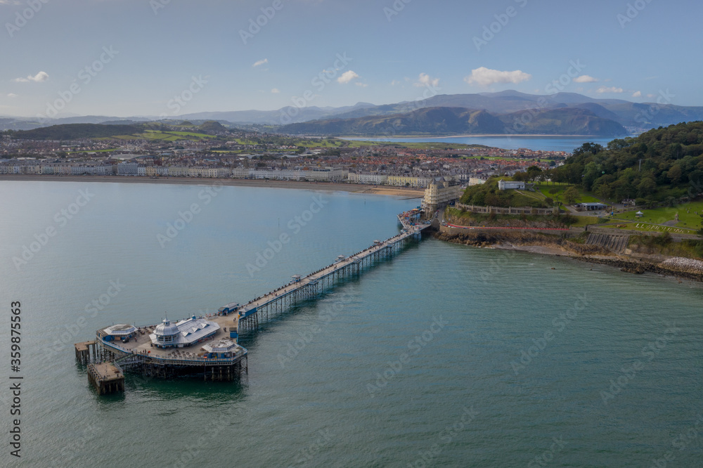 Llandudno Town and Pier North wales, the beach and sea. with Snowdonia mountains in the background. Aerial photograph