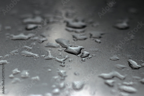 Drops of water on the car after rain. Drops of rain. Silver texture