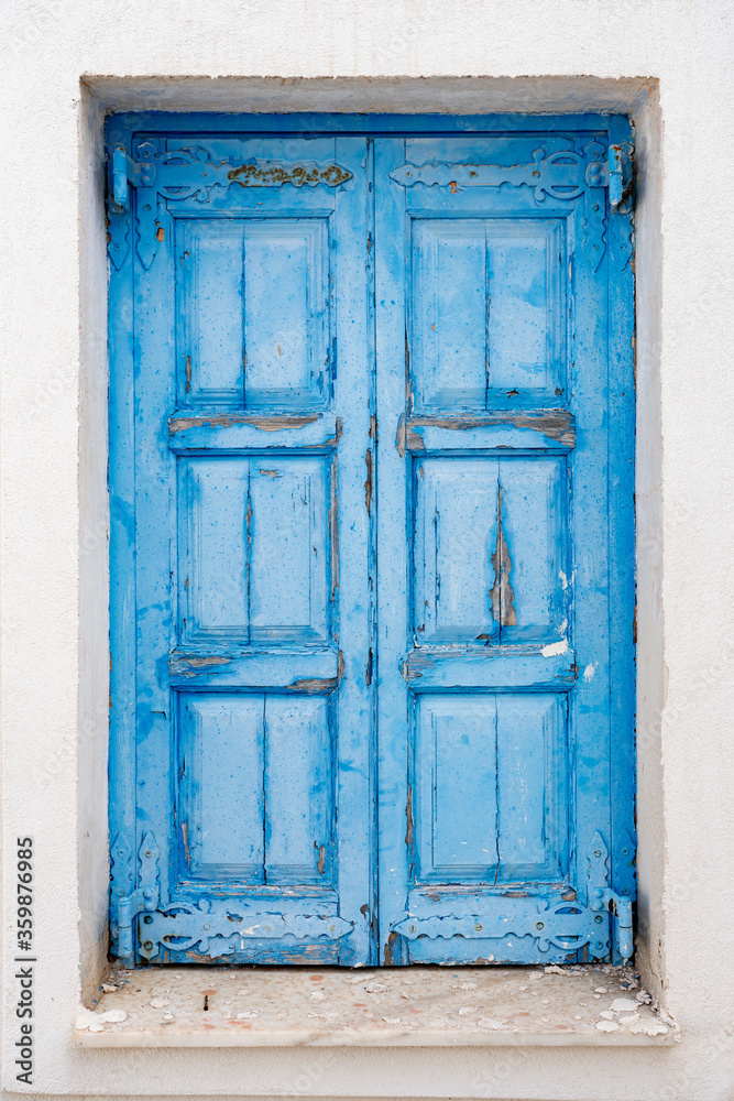 Santorini Greece, faded old rustic blue door on the island of Santorini Greece, traditional greek colours sunlight fade tourism greek islands