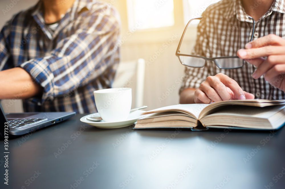 Two students are studying to find information about doing academic projects. Two students are studying to find information about doing academic projects.