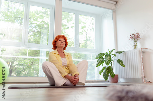 Senior woman doing stetch out exercises photo