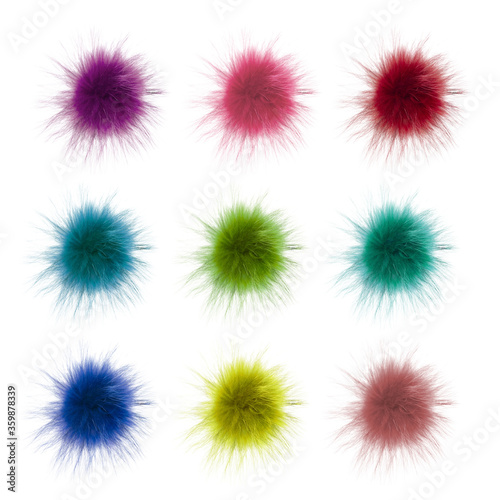 Fluffy multi-colored balls of fur isolated on a white background. Set of soft pompons. Item of clothing, decor, rabbit tail, handmade.
