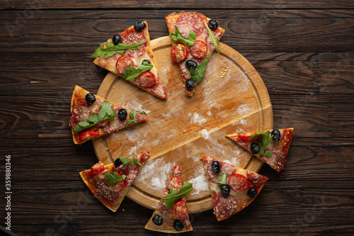 Process of making homemade pizza with mozzarella olives and salami, top view photo