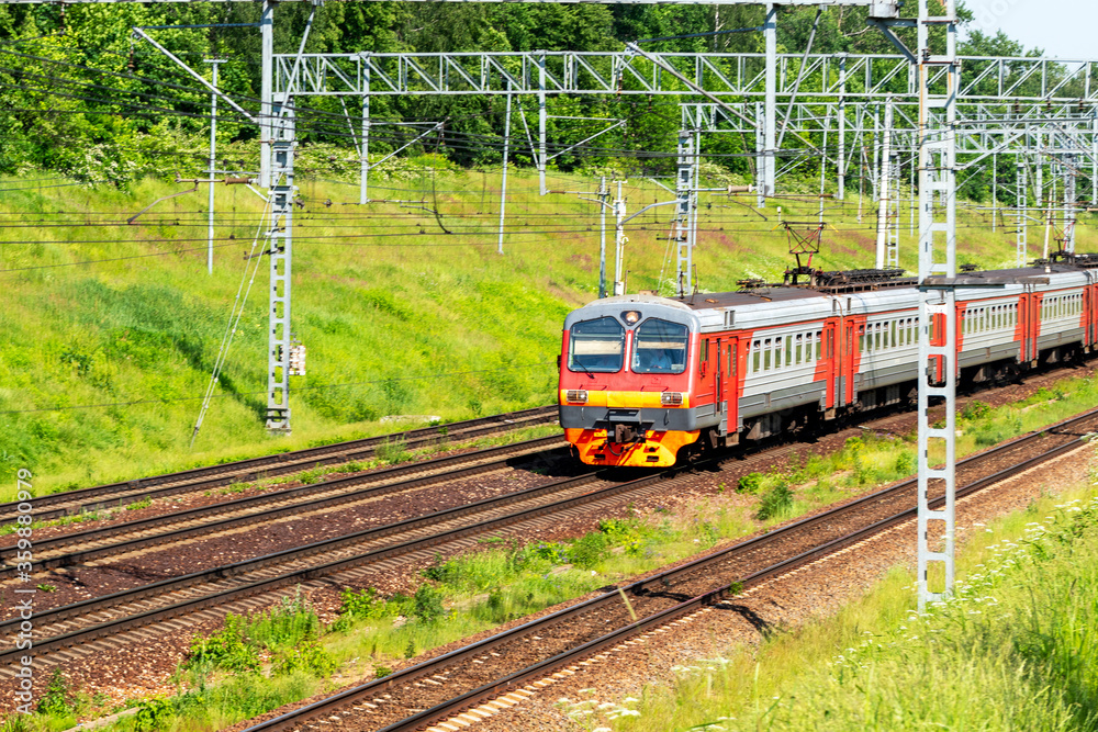Naklejka premium Suburban electric train on a sunny summer day. Soft focus.